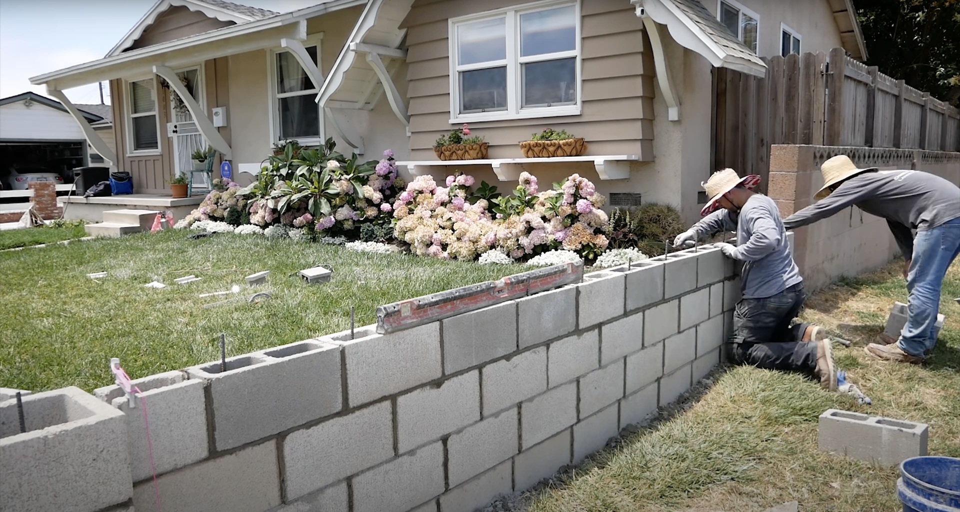 Professional retaining wall installation in Hudson neighborhood Concrete block retaining wall construction in residential setting