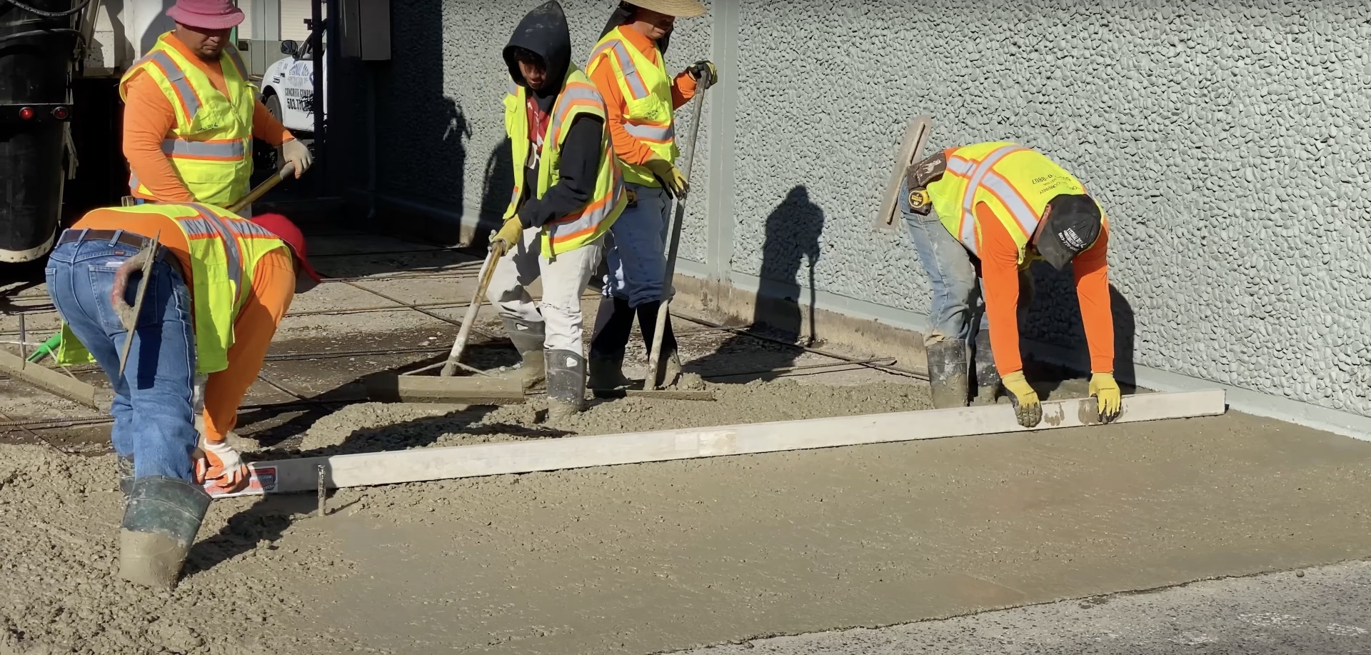 Professional concrete team executing large-scale project Commercial concrete crew performing precision finishing work