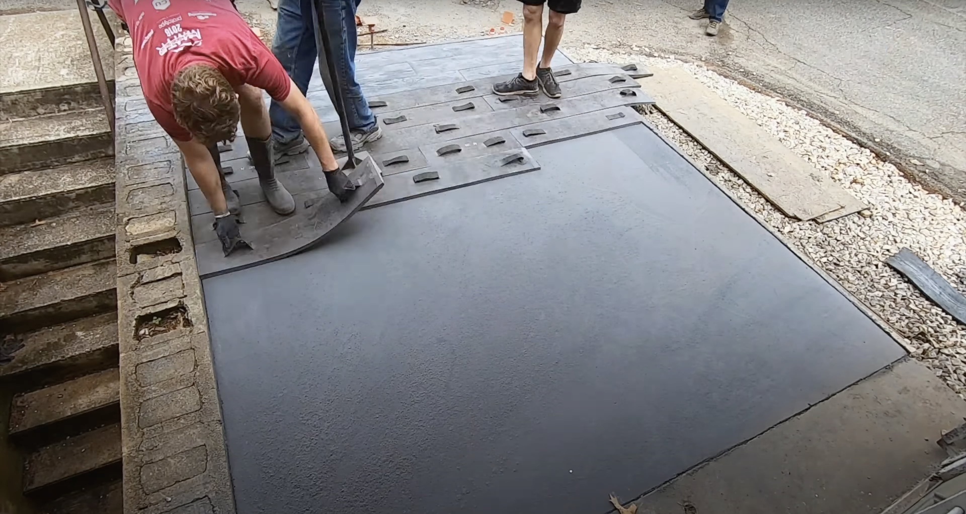 Stamped concrete installation showing professional craftsmanship Concrete stamping work creating decorative patterns and textures